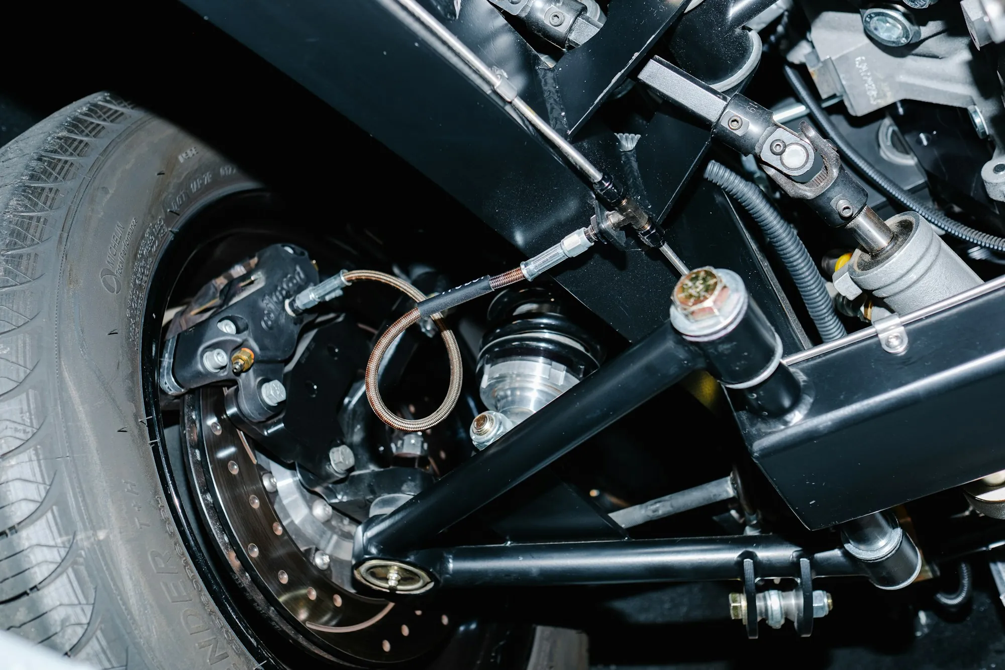 Suspension components and brake disc under a lifted vehicle